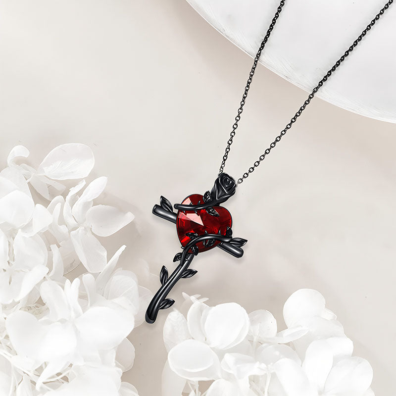 Black rose sterling silver necklace with a red heart gemstone and intricate design
