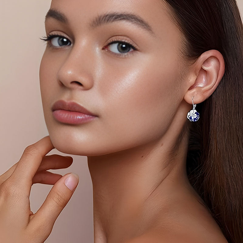 Origsoul blue floral dangle earrings for women worn by a model with sleek hair and natural makeup