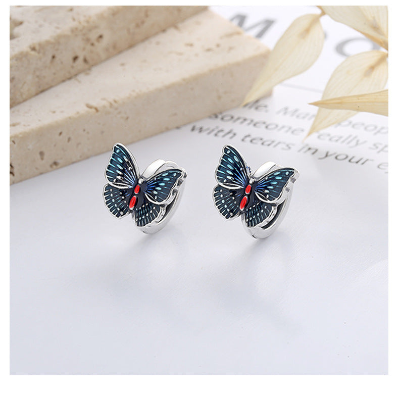 Origsoul butterfly earrings for women with blue and red enamel detailing on silver hoops