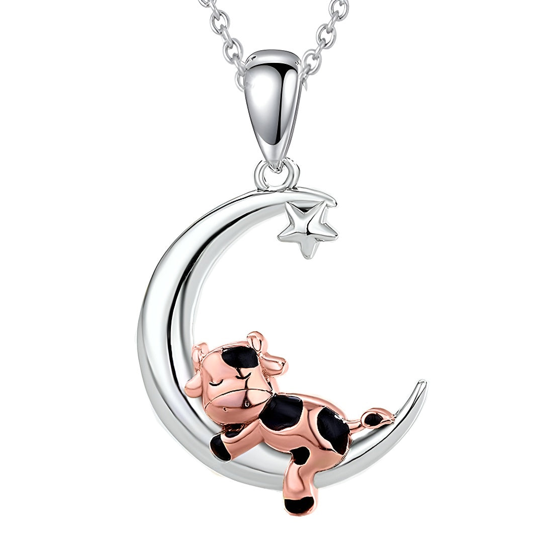Cartoon cow moon pendant necklace in silver and rose gold with a playful cow design on a crescent moon