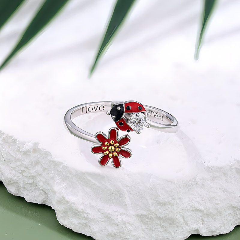 Origsoul colorful ladybug ring with red flower and silver band on white textured surface
