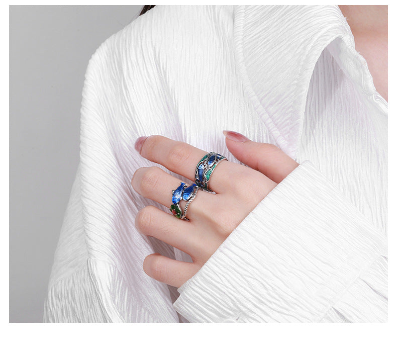 Origsoul colorful lotus carp ring worn on hand with white textured fabric background