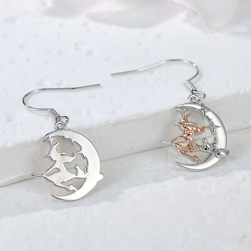 Origsoul crescent moon dangle earrings with witch riding broom design in silver and rose gold tones
