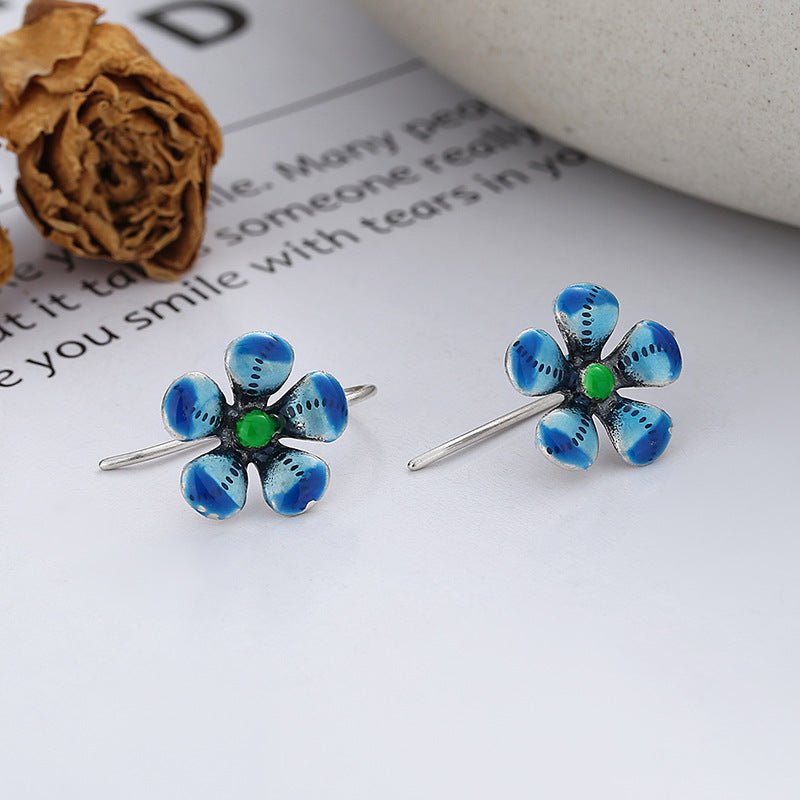 Origsoul daisy tassel earrings featuring blue flower design with green center on silver hooks