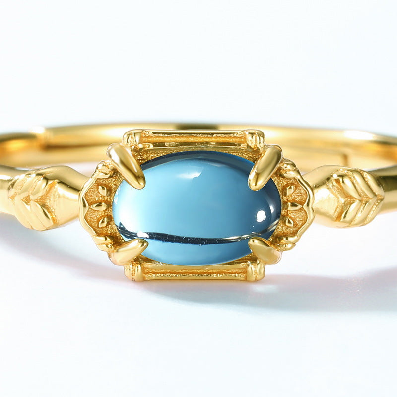Origsoul elegant blue topaz engagement ring with gold band and intricate leaf design