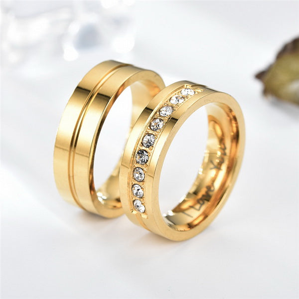 Origsoul gold zircon wedding bands set with one band featuring clear zircon stones and the other with a smooth finish