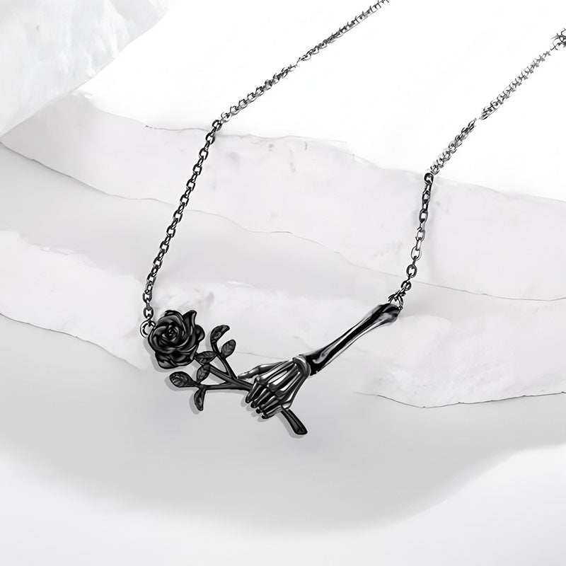 Origsoul Halloween gothic jewelry for women featuring black skeleton hand holding a rose necklace