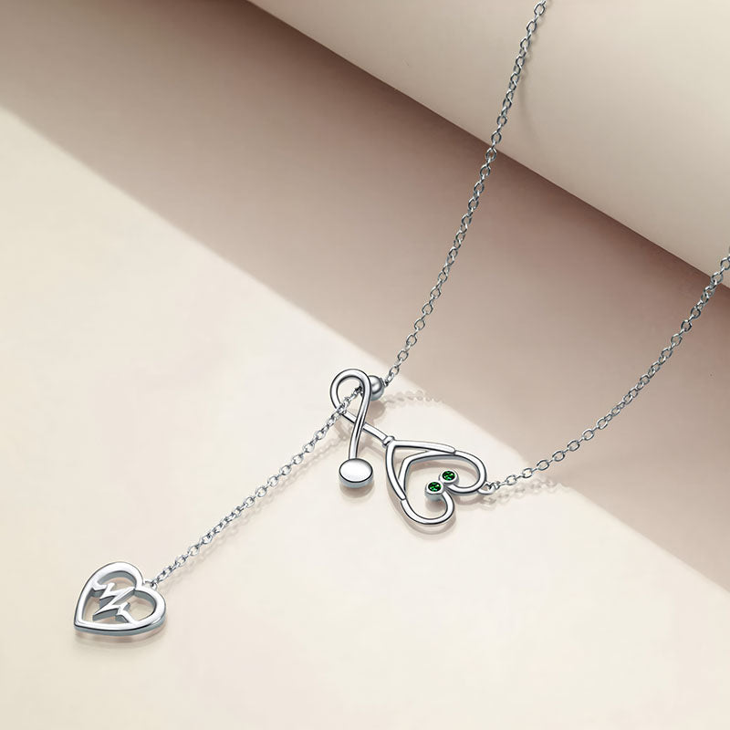 Origsoul silver infinity heart stethoscope necklace with green gemstone accents on a delicate chain