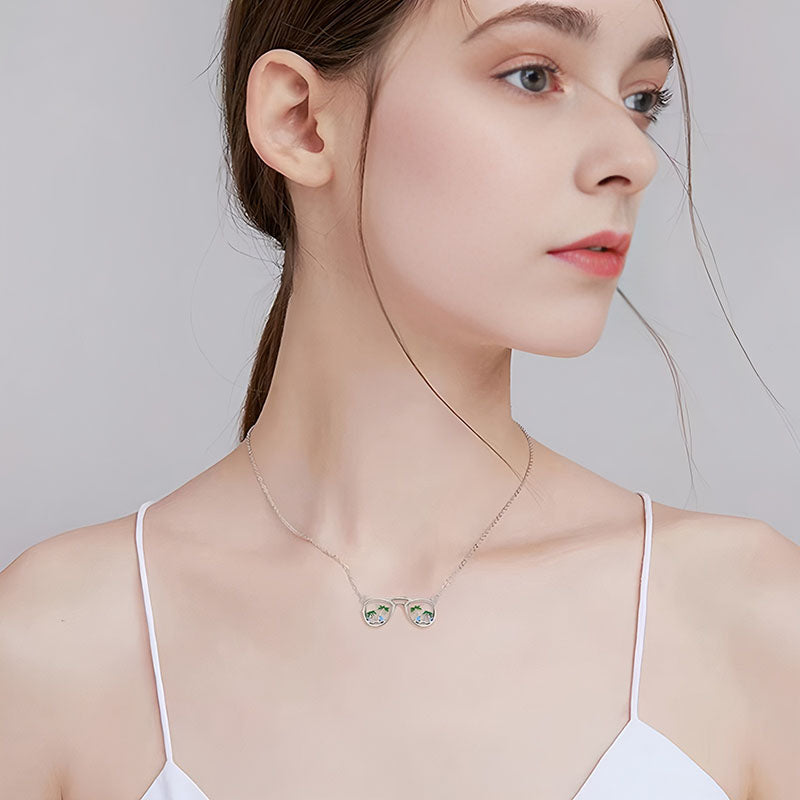 Origsoul beach sunglasses necklace worn by woman with silver chain and detailed pendant