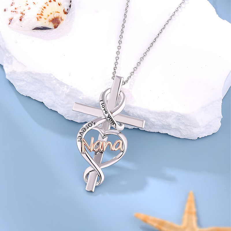 Origsoul Nana heart cross necklace with silver chain and love you engravings on light blue background