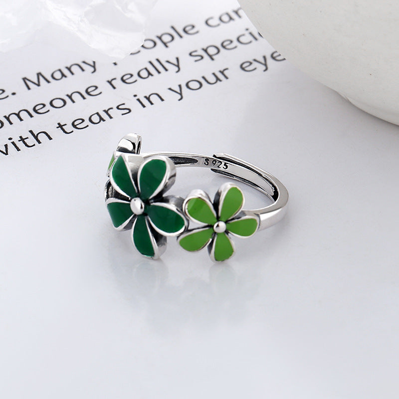 Origsoul October birth flower ring featuring two green enamel flowers on a sterling silver band