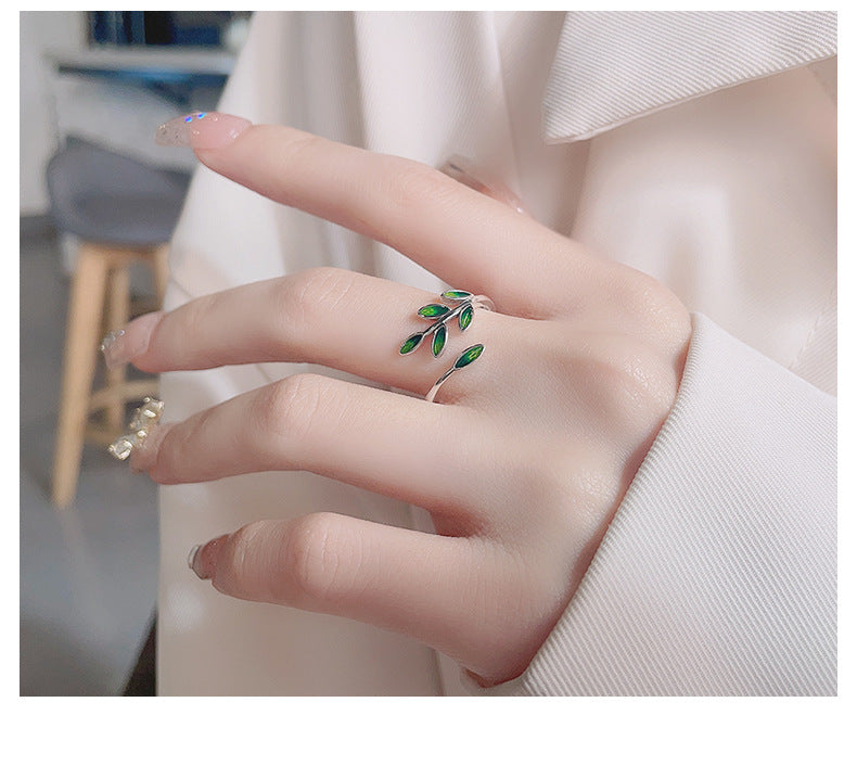 Origsoul olive leaf ring with green enamel leaves on a silver band worn on hand