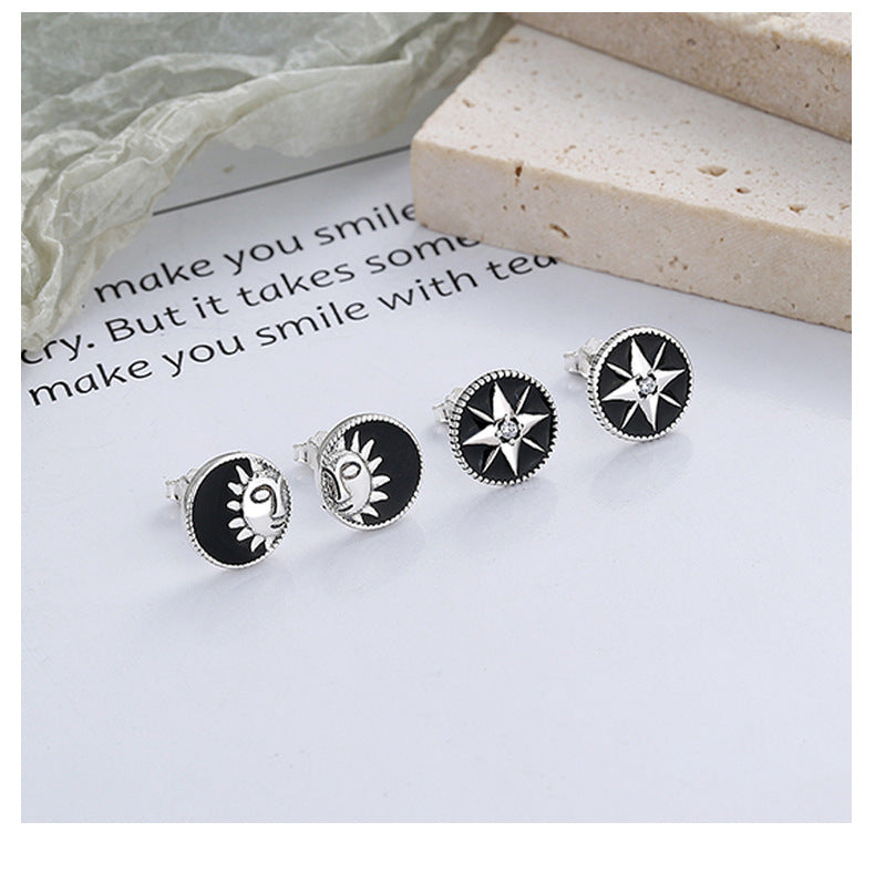 Origsoul retro black enamel earrings set with cosmic sun and star designs on silver studs