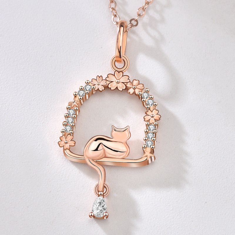 Origsoul rose gold cat necklace with floral and crystal details on a delicate chain