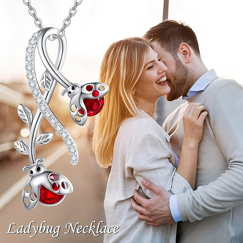 Origsoul S925 ladybug vine necklace with red enamel accents, featured on a couple sharing a joyful moment