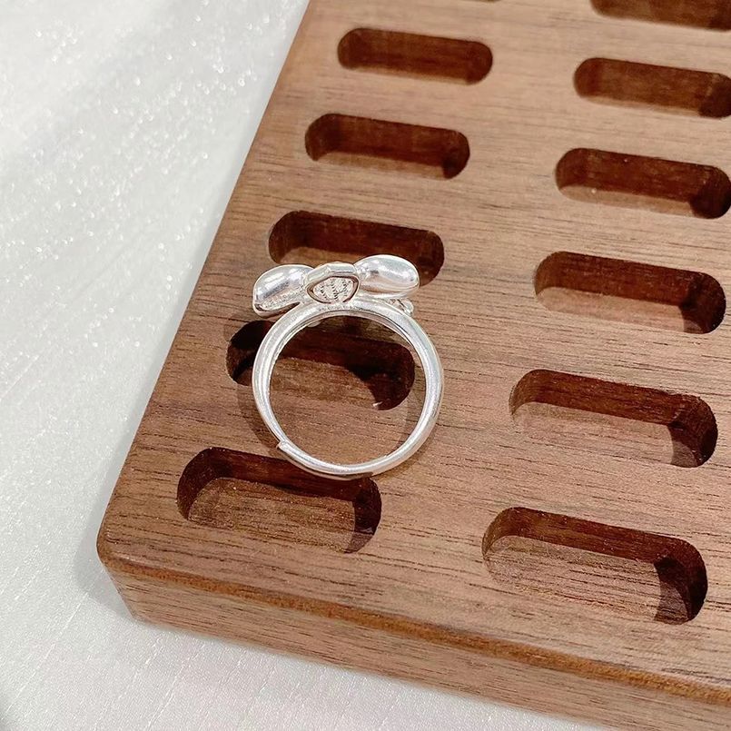 Origsoul silver March birth flower ring displayed on a wooden jewelry holder