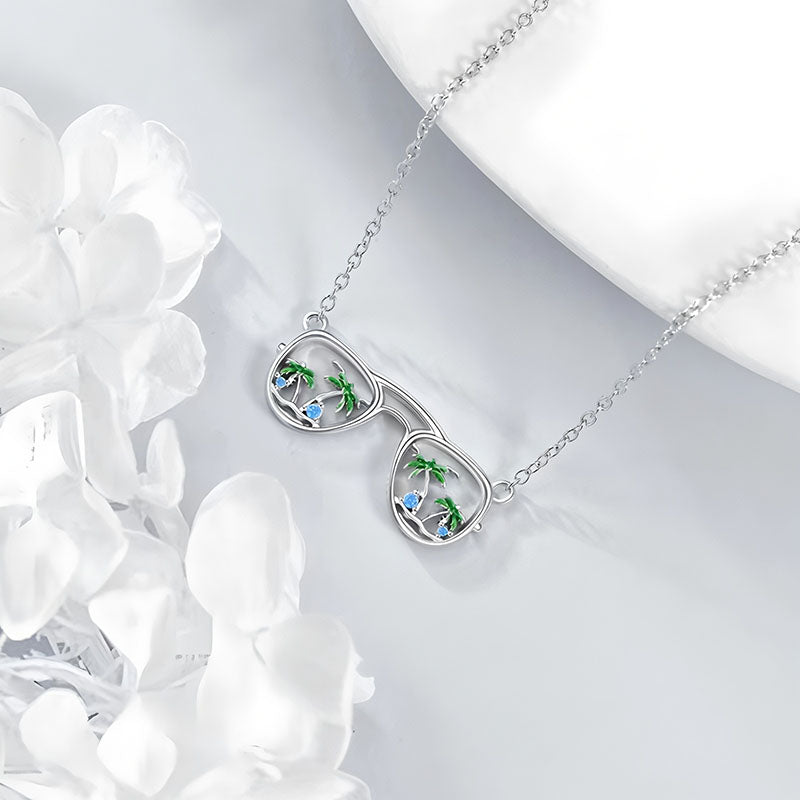 Origsoul silver beach sunglasses necklace with palm tree and blue gem accents on delicate chain