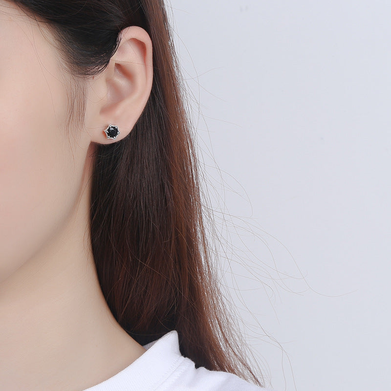Origsoul cosmic jewelry black gemstone star stud earrings on model ear