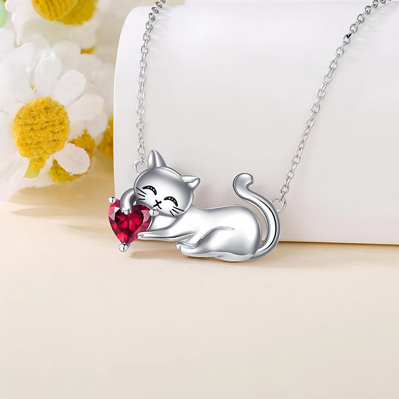 Origsoul silver cat necklace featuring a playful cat holding a red heart-shaped gem pendant