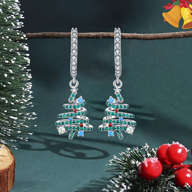 Origsoul Christmas tree hoop earrings with green, blue, and red stones hanging on a branch for festive jewelry