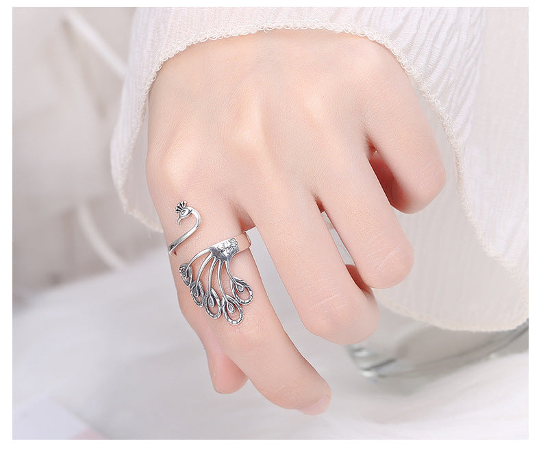 Origsoul peacock adjustable ring for women in silver worn on finger with detailed feather design