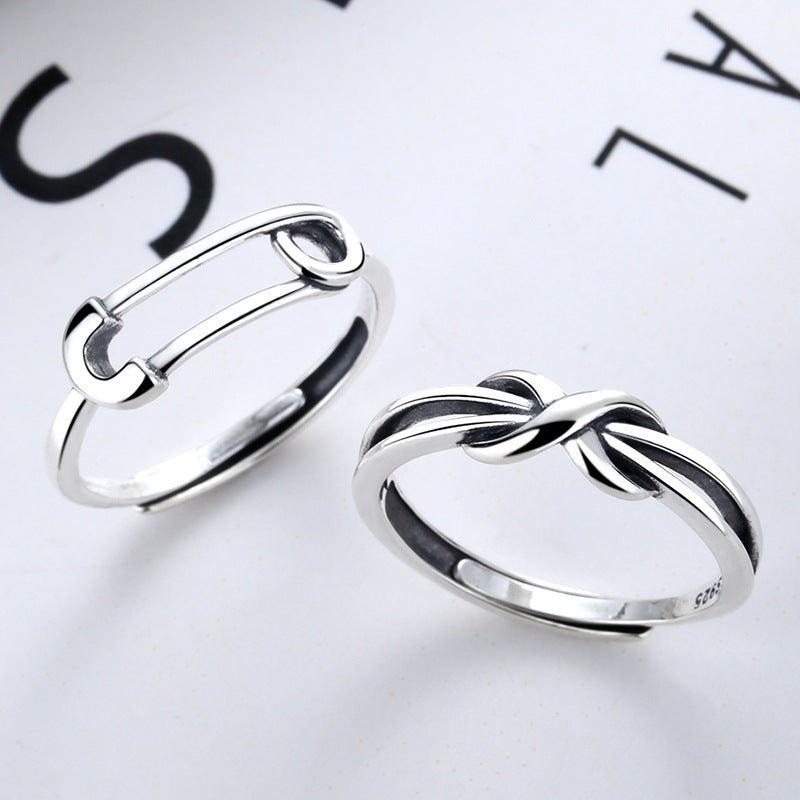 Origsoul silver safety pin ring displayed alongside a twisted design silver ring on white background