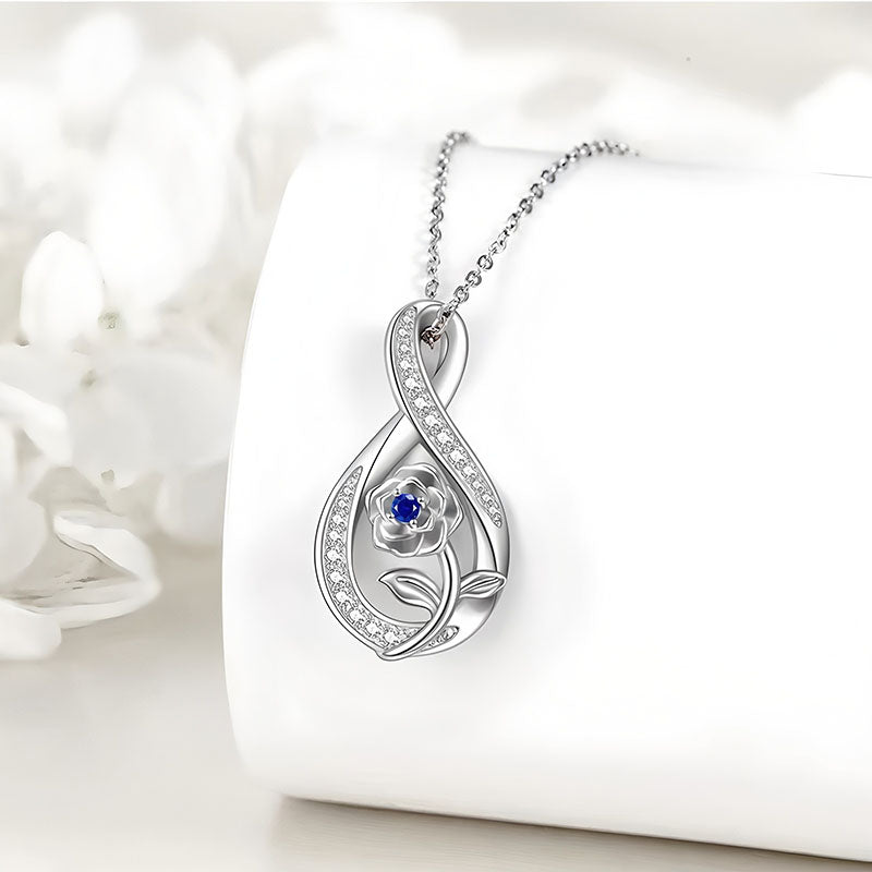 Origsoul September birthstone necklace with silver floral pendant and blue sapphire stone