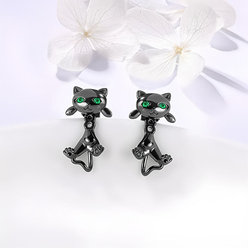 Origsoul black metal cat face earrings with green eyes and playful design on white background
