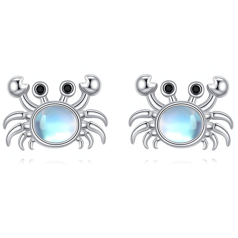 Origsoul sterling silver crab earrings with sparkling blue center stone and intricate detailing