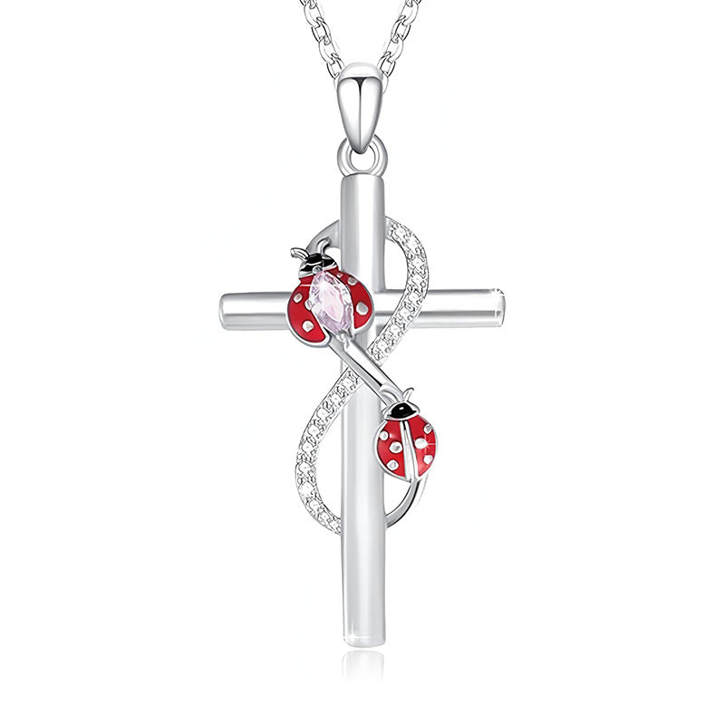 Sterling silver cross ladybug necklace featuring red enamel ladybugs and sparkling details