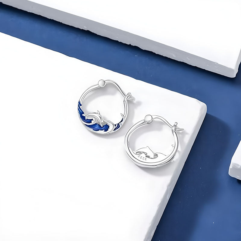Origsoul sterling silver dolphin earrings with intricate design and a blue accent