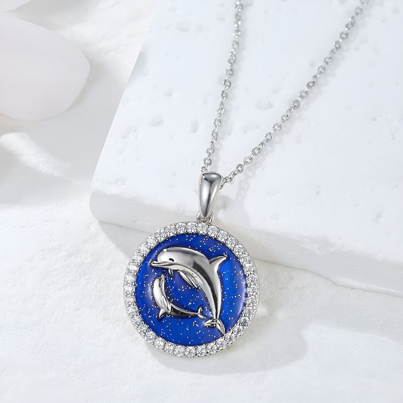 Origsoul sterling silver dolphin pendant necklace with blue background and sparkling accents