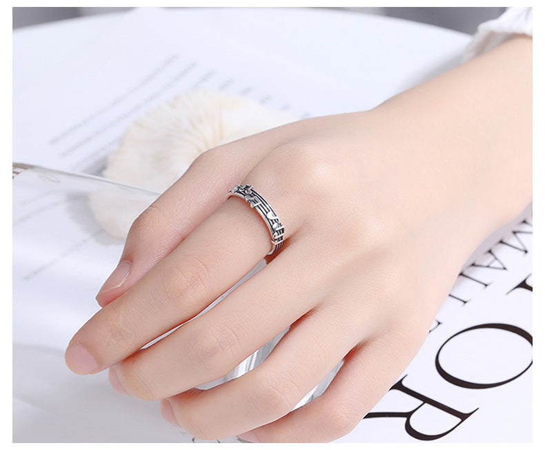 Origsoul music note eternity ring on a hand featuring detailed musical notes design in silver