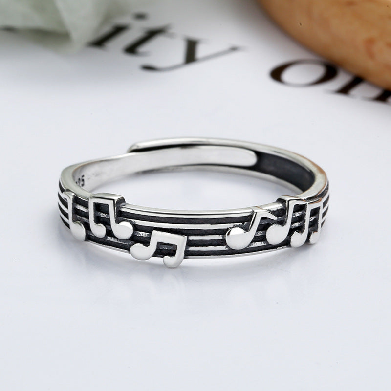 Origsoul music note eternity ring in silver with musical notes design on a black striped band