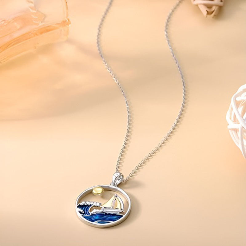 Origsoul sterling silver nautical necklace featuring a sailboat and waves with a sun design