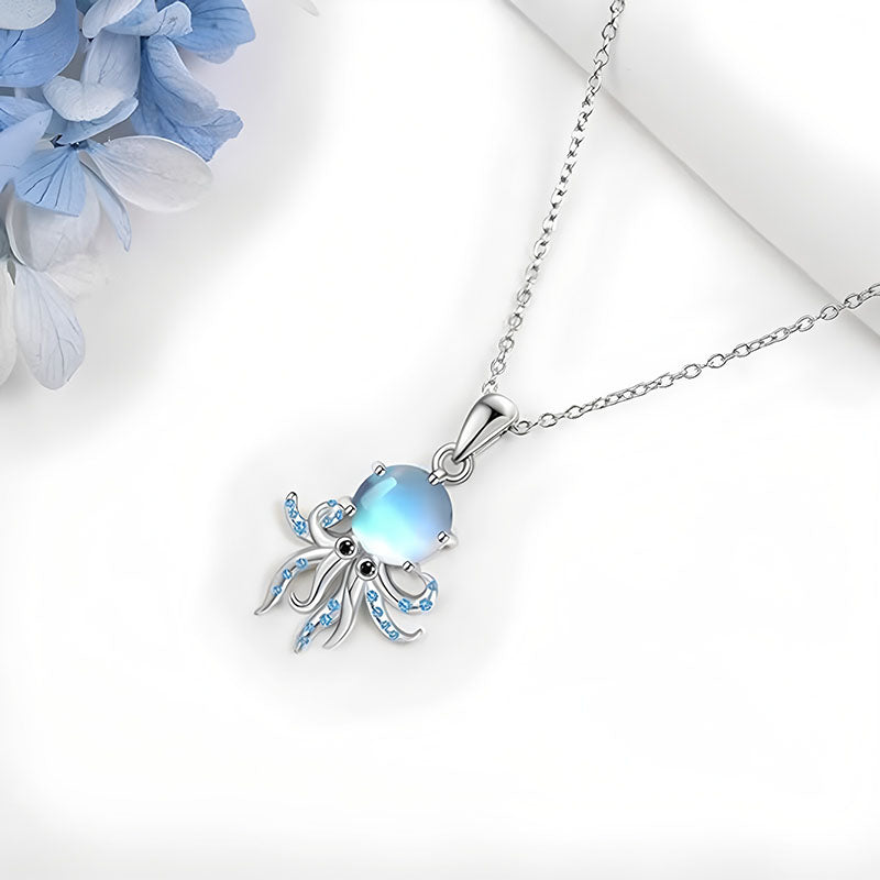 Origsoul sterling silver octopus pendant with blue gemstones and iridescent center on a delicate chain