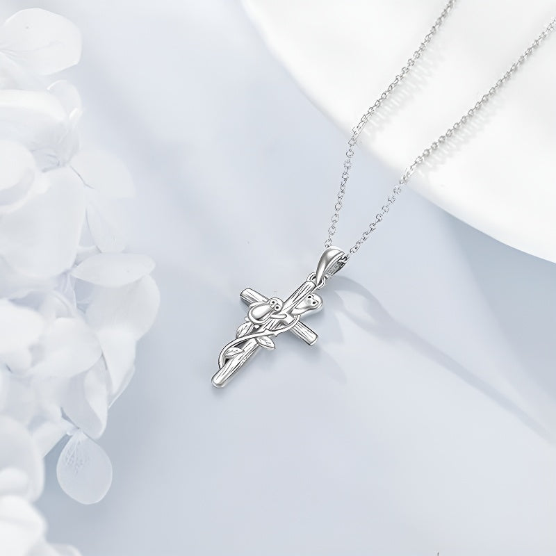 Origsoul sterling silver penguin cross necklace elegantly displayed with soft floral background