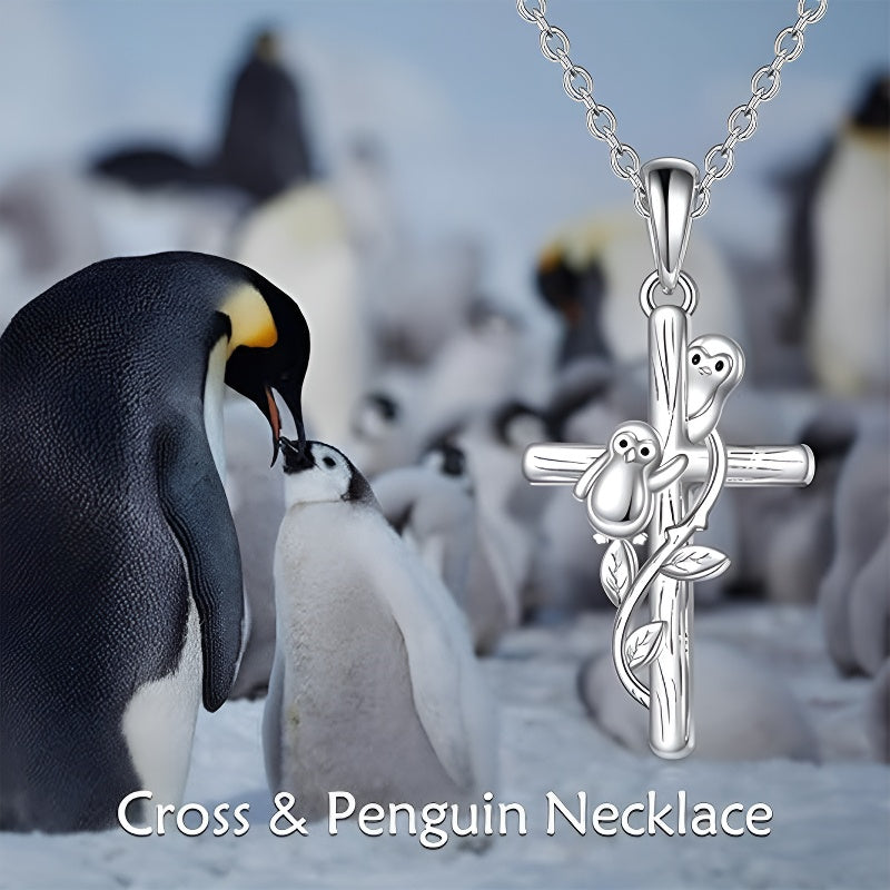 Sterling silver penguin cross necklace featuring adorable penguin figures and floral design