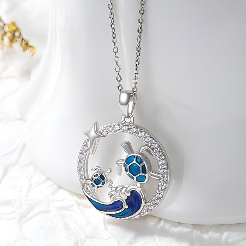 Origsoul sterling silver turtle necklace featuring a turtle and wave design with blue enamel and sparkling accents