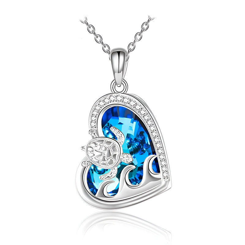 Origsoul sterling silver turtle necklace featuring a blue crystal heart pendant with wave detail