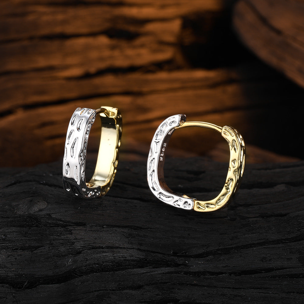 Origsoul unique gold hoop earrings with textured two-tone design on dark wooden background