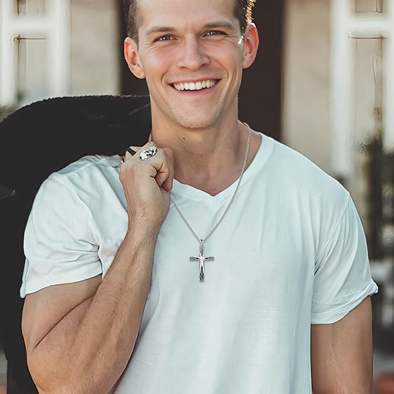 Man wearing a unique silver cross necklace gift from Origsoul with a white t-shirt smiling outdoors