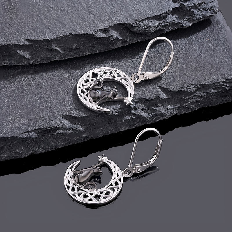 Origsoul cat and moon Celtic earrings in silver featuring a crescent moon and cat design on dark stone background