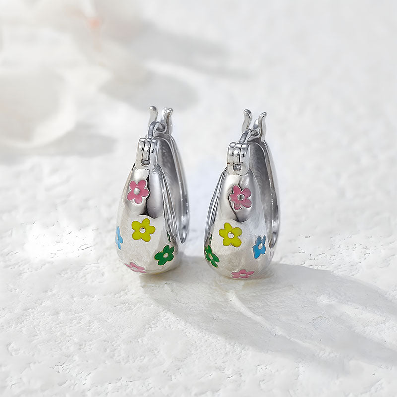 Origsoul colorful flower hoop earrings with pink, yellow, green, and blue flower designs on silver hoops