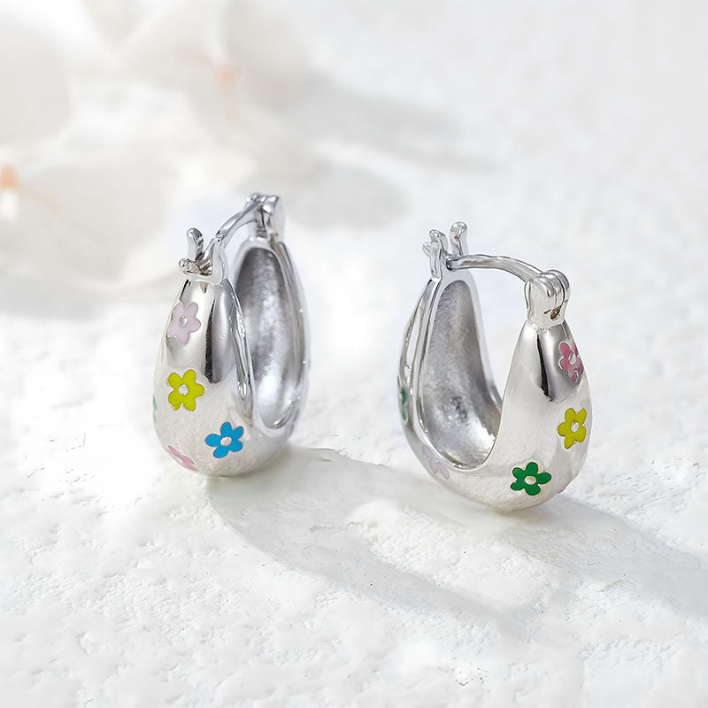 Origsoul colorful flower hoop earrings in silver with multicolored floral designs on white background