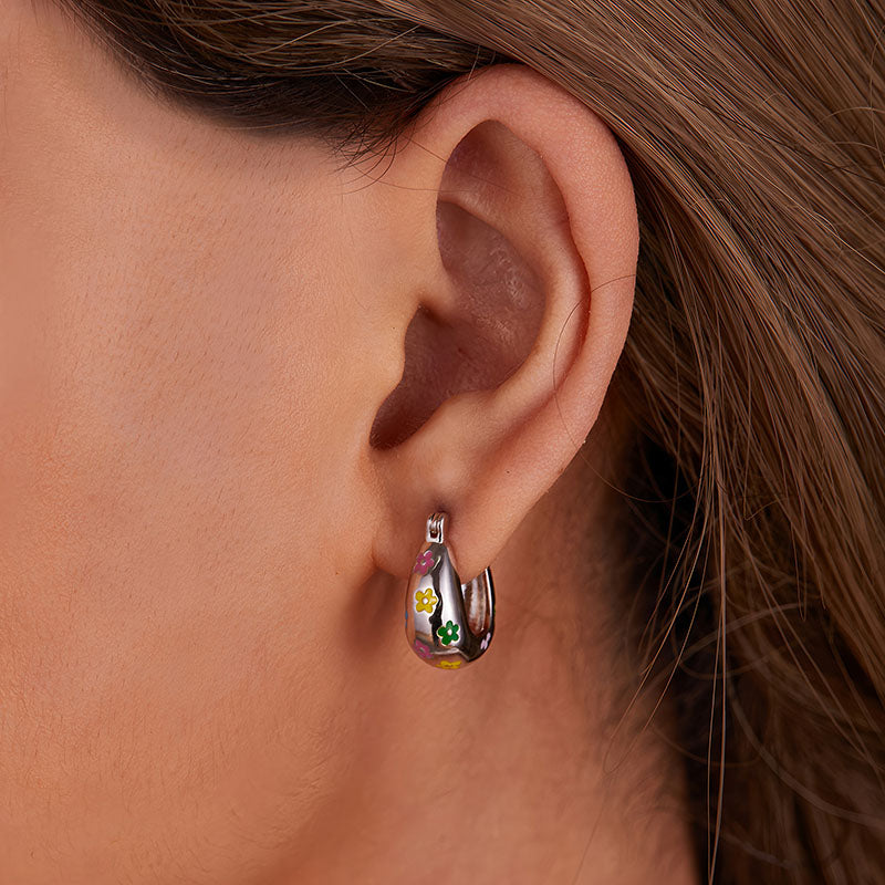 Origsoul colorful flower hoop earrings worn on ear featuring multicolor floral design on silver hoops