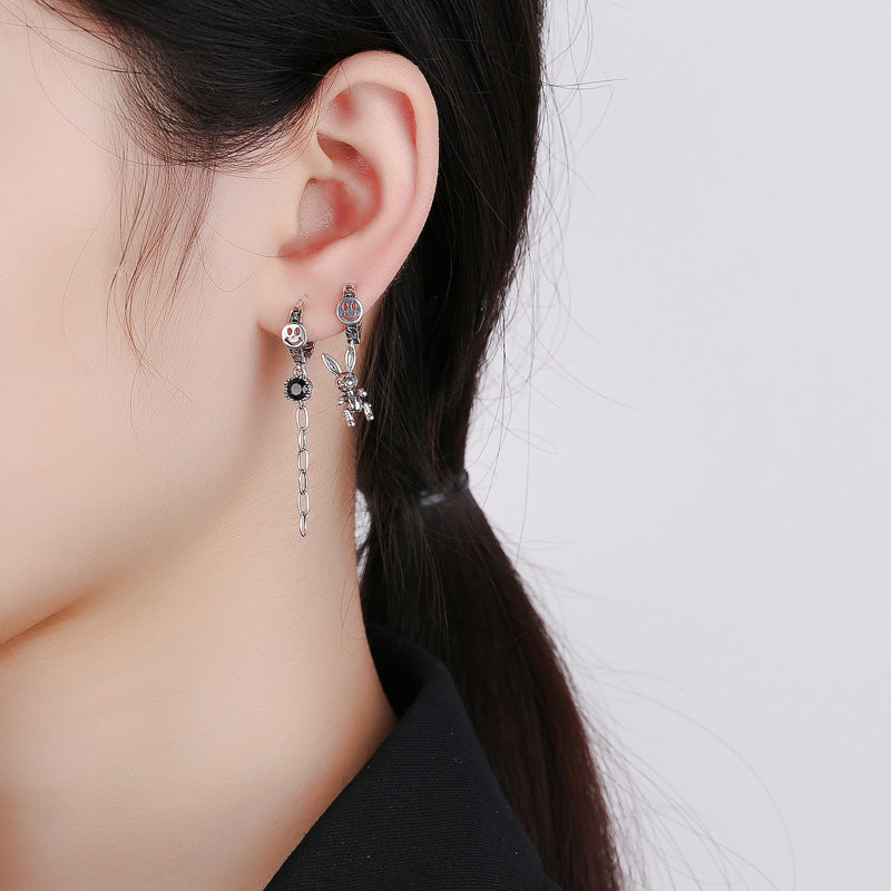 Origsoul cute rabbit charm earrings in silver worn on ear with chain and flower details