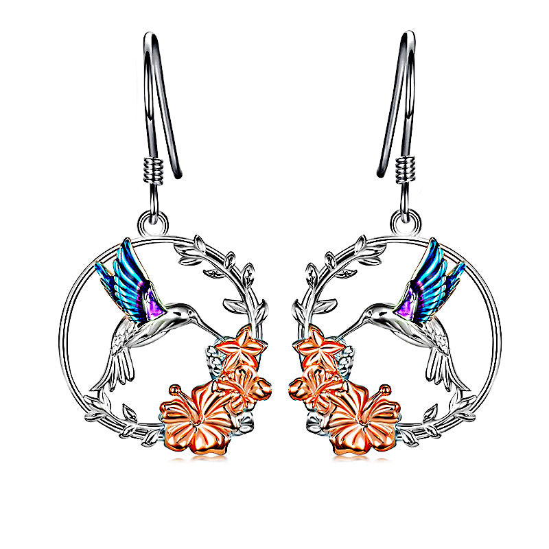 Origsoul handcrafted bird drop earrings featuring silver hoops with colorful hummingbirds and orange flowers