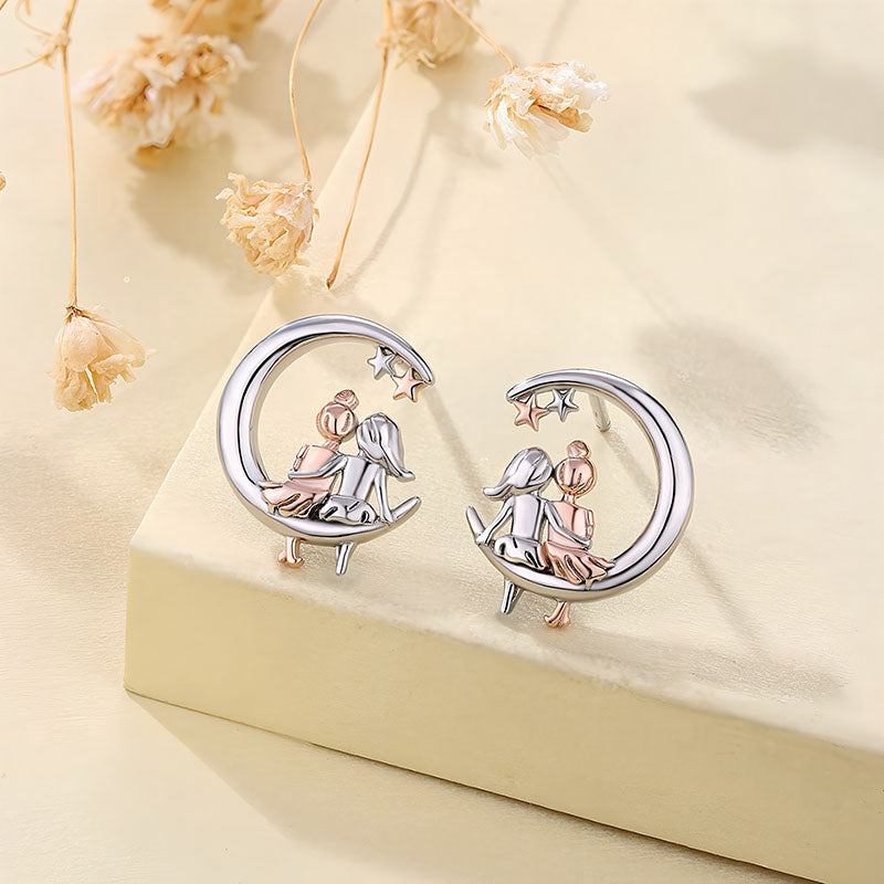 Origsoul moon and star fashion earrings featuring two girls sitting on crescent moons with stars