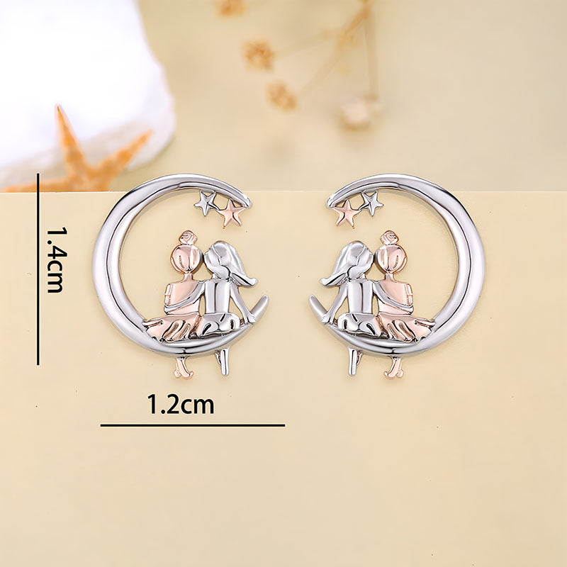 Origsoul moon and star fashion earrings featuring a silver crescent moon with two children sitting inside